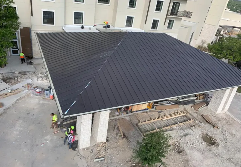 Metal roofing installation team working on a commercial building in Kent
