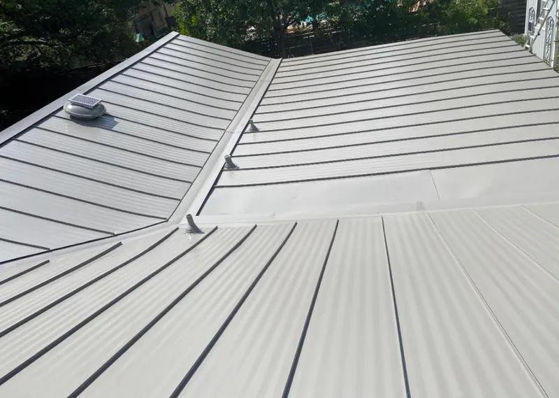 Solar attic fan installed on a metal roof for Roof Ventilation in Kent